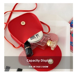 Detail of red PU leather girls' mini bag showing interior storage space with magnetic snap