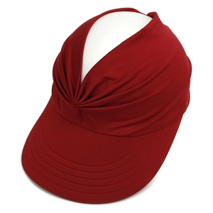 Detail of burgundy open top sun hat showing knot design and stitched brim on a model