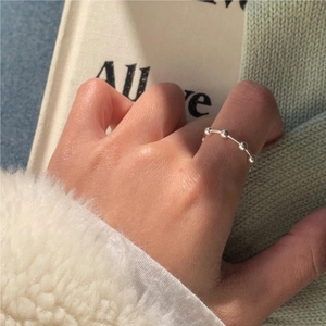 Minimalist 925 sterling silver beaded ring shown on hand with soft elegant aesthetic