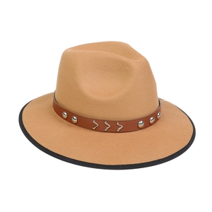 Close-up of khaki fedora with brown leather belt, silver studs and metal arrow accents