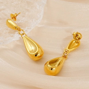 Polished 18K gold stainless steel hollow teardrop earrings on elegant silk fabric