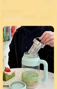 Detail of detachable large tea infuser and heat-resistant glass cup with silicone sleeve