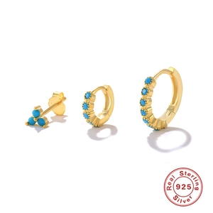 Detailed macro of gold S925 sterling silver hoop earrings with blue turquoise beads