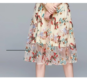 Detail of elegant floral embroidery on double-layered mesh skirt with vintage botanic patterns