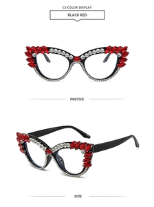 Detail of oversized black cat-eye glasses with sparkling red and white rhinestones