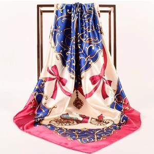 Detailed view of satin scarf with horse carriage print draped on a metal frame