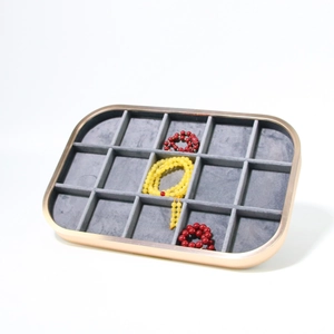 Gray microfiber jewelry display tray with 12 slots and a gold aluminum metal frame