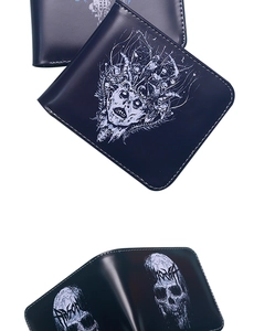 Detail of dark skull print leather wallet showing interior slots and gothic design