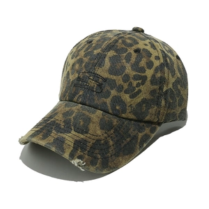 Close-up of leopard print baseball cap featuring vintage distressed edges and black embroidery