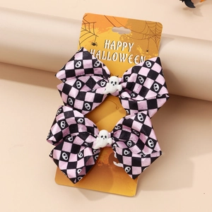 Detail of Halloween bow hair clips with ghost charms on checkerboard pattern card