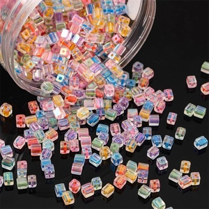5mm iridescent glass cube beads spilling from jar for DIY jewelry making and crafts