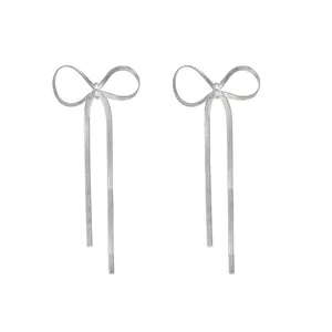 Minimalist silver bow knot tassel drop earrings made of sleek stainless steel snake chains