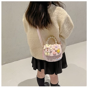 Detail view of pink girls teddy bear crossbody bag with lace texture and pearl handle