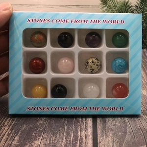 12 mixed natural stone spheres in a gift box with STONES COME FROM THE WORLD text