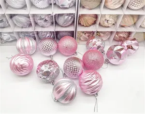 Close-up of pink and silver Christmas balls with various textures and glitter patterns