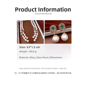 Detail of vintage necklace set with double layer pearls and green stones on gold alloy