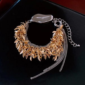 Detail of multi-layer leaf tassel bracelet with gold leaves and silver mirror plate