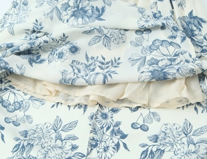 Detailed macro view of vintage floral chiffon fabric with smooth inner lining and neat stitching