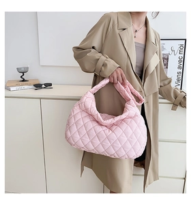 Detail of pink quilted puffer shoulder bag showing soft texture and large capacity