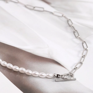 Detail of paperclip chain and white pearl necklace with T-bar toggle clasp closure