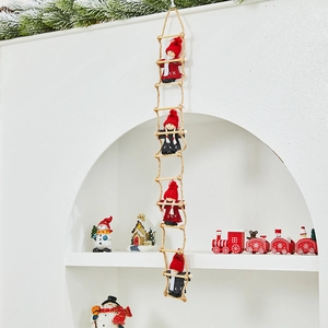 Christmas hanging decoration featuring four plush dolls climbing a rustic hemp rope ladder