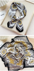 Detailed view of yellow and grey silk square scarf with bohemian paisley patterns