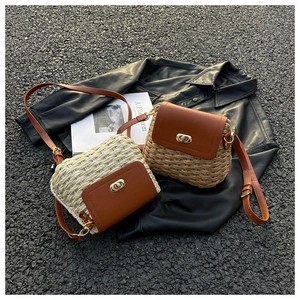 Detail of woven straw crossbody bags in khaki and beige with brown leather flaps and locks