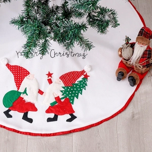 White Christmas tree skirt with Merry Christmas text and festive Santa Claus figures