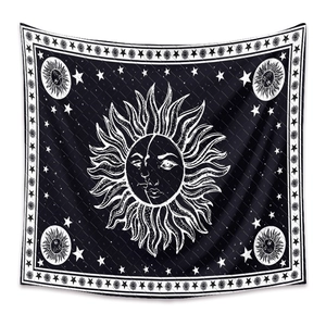 Close-up of black and white bohemian sun and moon tapestry with astrology symbols