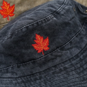 Unisex wide brim bucket hat with red maple leaf embroidery on dark gray washed cotton