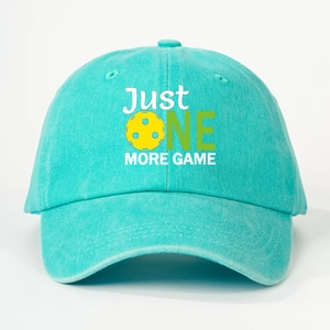 Detail of mint green cotton baseball cap with JUST ONE MORE GAME pickleball print
