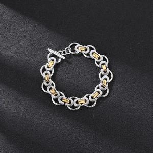 Detail of silver and gold Byzantine chain necklace with T-bar clasp on black background