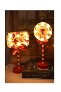Detail of LED Christmas stop sign lamps with snowman and reindeer on wooden base