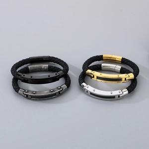 Close-up of men's braided leather bracelets with black gold silver and gunmetal clasps