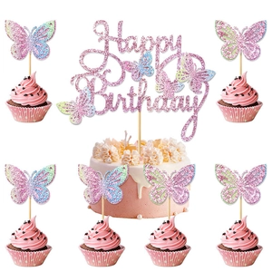 Close-up of pink glitter butterfly cake toppers with Happy Birthday sign decoration
