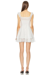 Detailed back view of a white French style lace dress with bow tie and layered ruffles