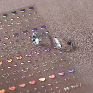 Macro detail of holographic heart nail stickers H-047 with metallic rose gold finish