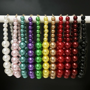 Detailed view of large pearl necklaces in various colors with high gloss and metal clasps