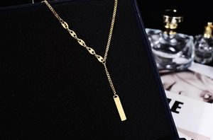 Detail shot of 18K gold plated bar pendant necklace with coffee bean links in a gift box