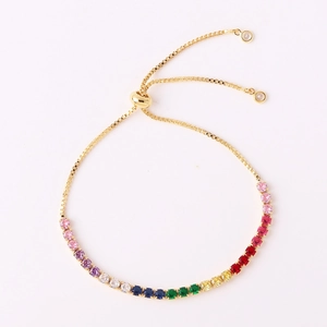Macro detail of rainbow zircon gold bracelet with adjustable bolo closure and colored stones