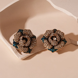 Vintage flower earrings with peacock blue enamel, sparkling rhinestones and aged gold finish