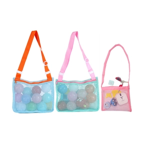Detail of mesh beach bags with zippers and colorful straps for sand toy storage