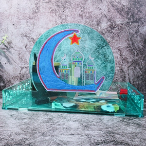 Macro view of a green acrylic tray with a moon and star pattern for holiday decor