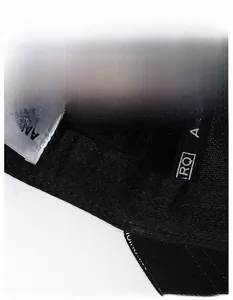 Detailed macro view of the interior moisture-wicking band on a black cotton baseball cap