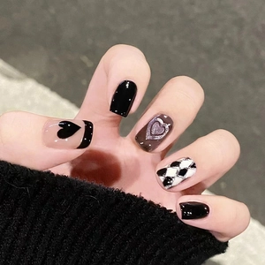 Short square fake nails with black heart, glitter outlines and checkerboard pattern