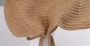 Detailed macro view of high-quality camel woven sun hat with adjustable chin strap