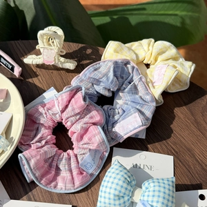 Close-up of pastel plaid hair scrunchies and bow clips with cute bear claw clip detail