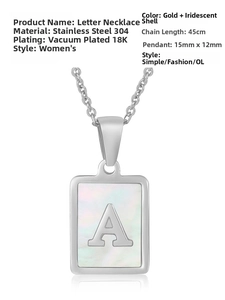Macro shot of stainless steel pendant featuring iridescent shell inlay and letter A detail