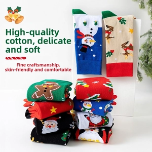 Detailed knit patterns of Santa and reindeer on festive cotton mid-calf socks