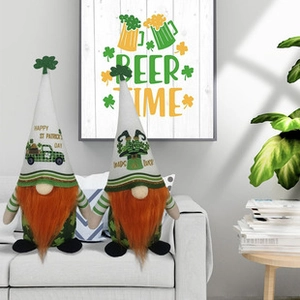 Two Saint Patrick's Day gnomes with green hats and orange beards on a cozy sofa decor